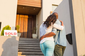 48190402 - back view of couple with arms above after buying house