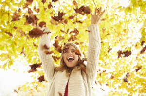 42270012 - woman throwing autumn leaves into the air