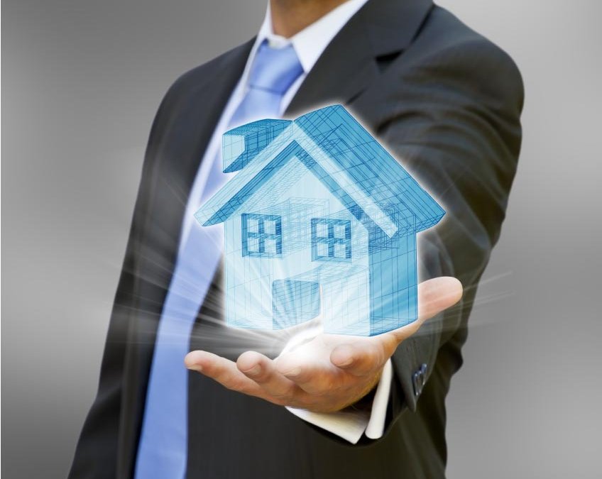 man in business suit holding a home in his hand